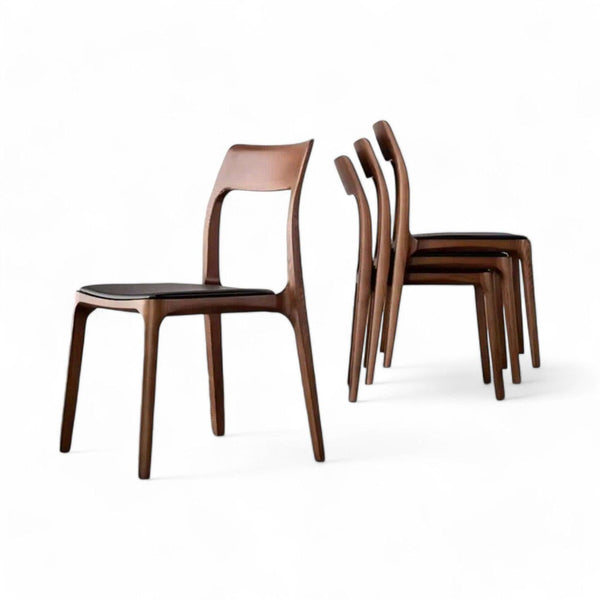 Sæt af spisebordsstole i valnød med polstret sort sæde – tidløst dansk design